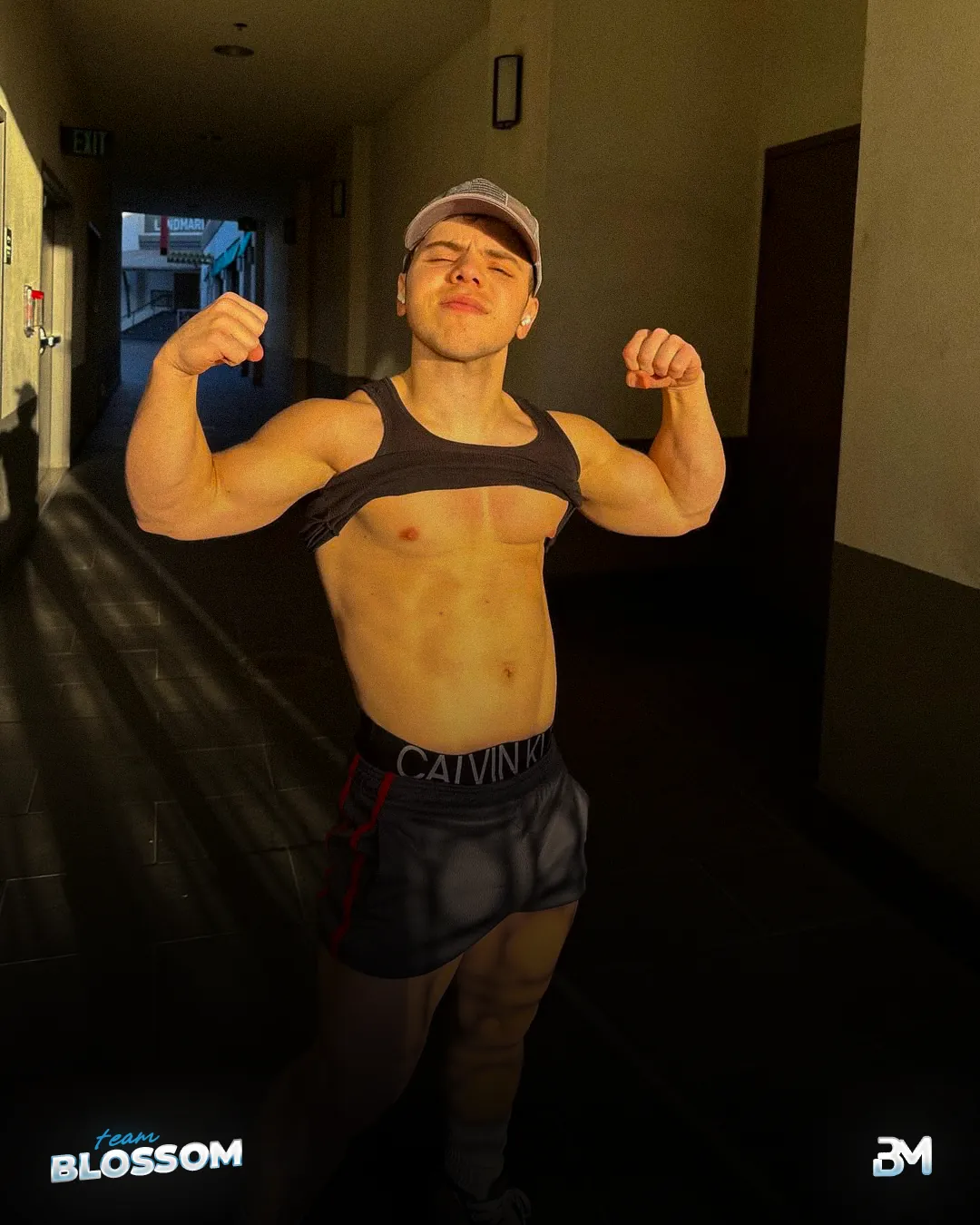 Blossom creator flexing in a hallway